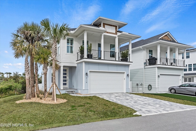 view of front of house with a balcony, a front yard, and a garage