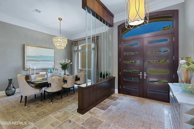 interior space featuring a notable chandelier, ornamental molding, and french doors