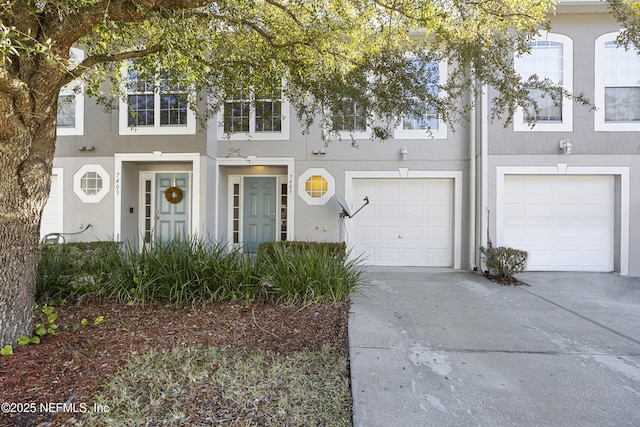 townhome / multi-family property featuring a garage