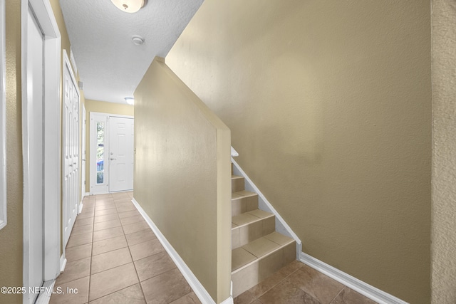 stairway with tile patterned flooring