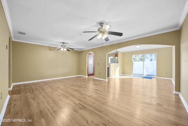 unfurnished room featuring a textured ceiling, ceiling fan, crown molding, and light hardwood / wood-style floors