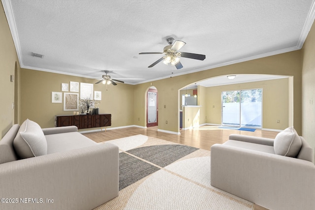 living room featuring crown molding, hardwood / wood-style floors, and a textured ceiling