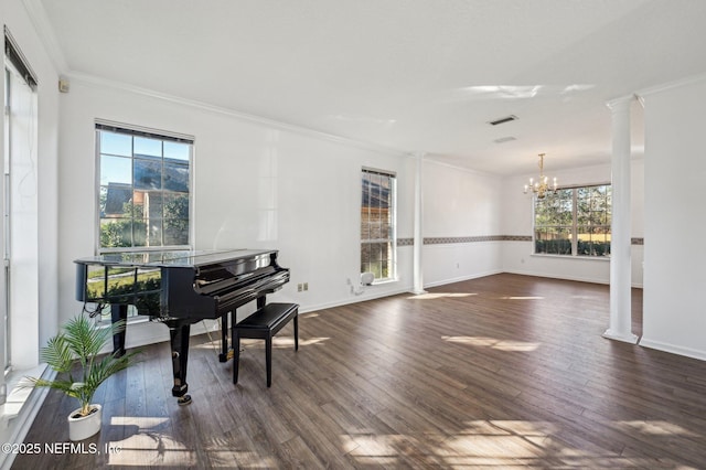 miscellaneous room featuring a chandelier, dark hardwood / wood-style floors, ornate columns, and ornamental molding