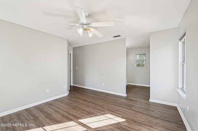 unfurnished room with dark hardwood / wood-style floors and ceiling fan