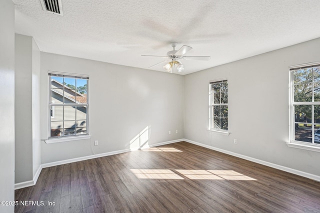 spare room featuring ceiling fan, dark hardwood / wood-style flooring, and a textured ceiling