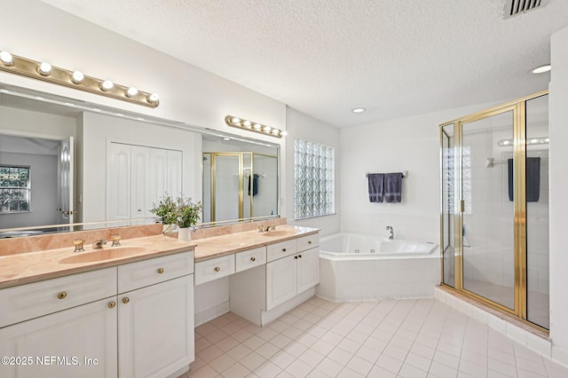 bathroom featuring vanity, a textured ceiling, separate shower and tub, and tile patterned flooring