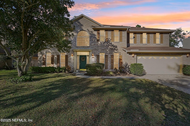 view of front of home featuring a lawn and a garage