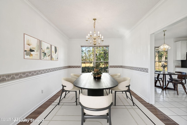 dining room featuring hardwood / wood-style floors, an inviting chandelier, and crown molding