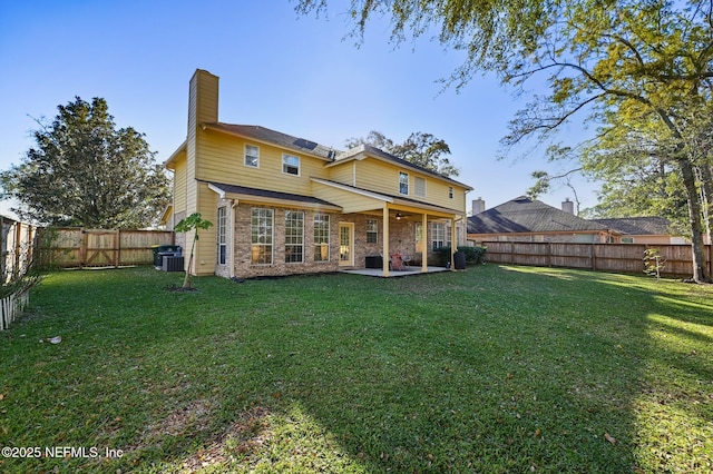 back of house featuring a yard, cooling unit, and a patio area