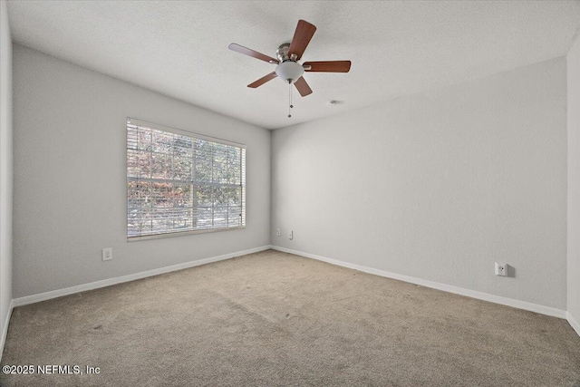 spare room featuring carpet and ceiling fan