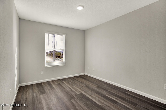 unfurnished room with dark hardwood / wood-style floors