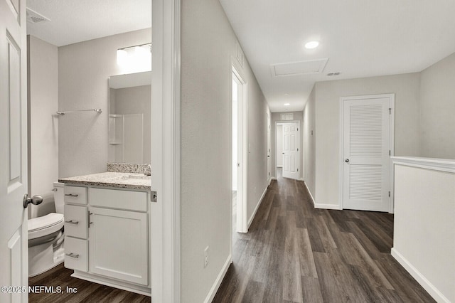 corridor featuring dark hardwood / wood-style flooring and sink