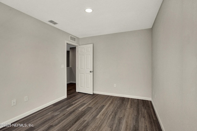 empty room featuring dark hardwood / wood-style flooring