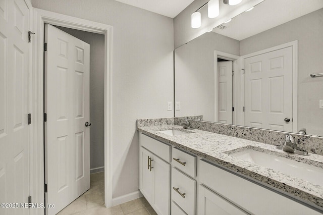 bathroom featuring tile patterned flooring and vanity