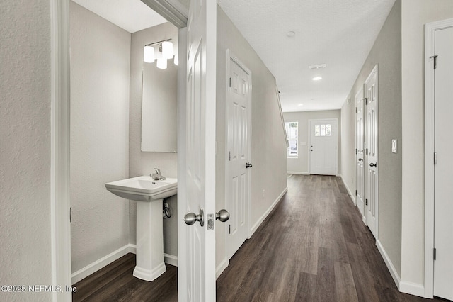 hallway with dark hardwood / wood-style flooring