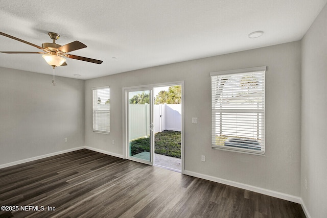 unfurnished room featuring ceiling fan and dark wood-type flooring