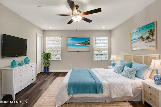 bedroom with multiple windows, ceiling fan, and dark hardwood / wood-style floors