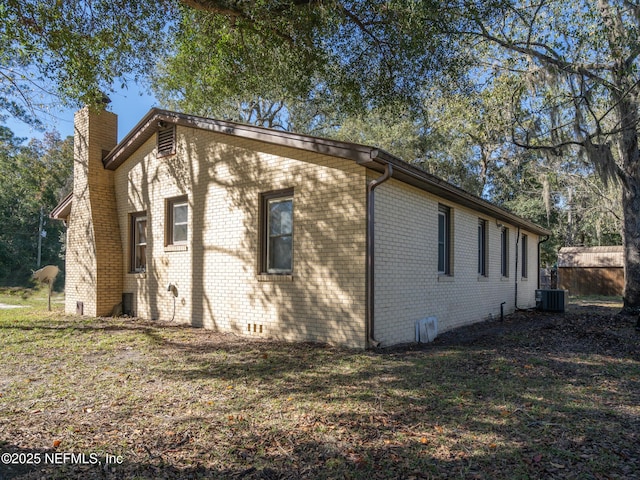 view of side of property with central air condition unit