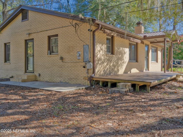 rear view of house featuring a patio and a deck