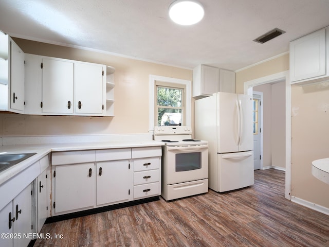 kitchen featuring crown molding, white cabinets, dark wood-type flooring, and white appliances