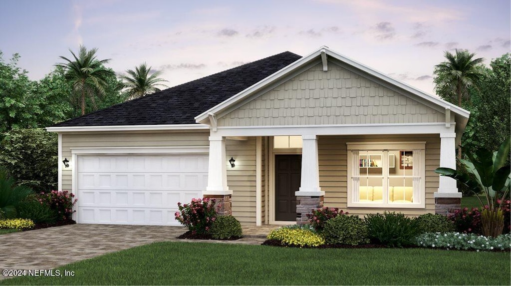 craftsman house with a garage and a yard