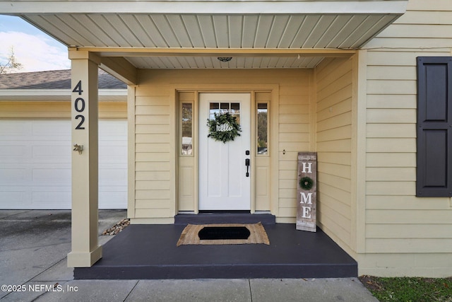 doorway to property with a garage