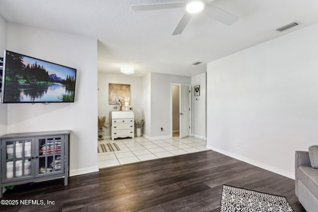 living room with ceiling fan and hardwood / wood-style flooring