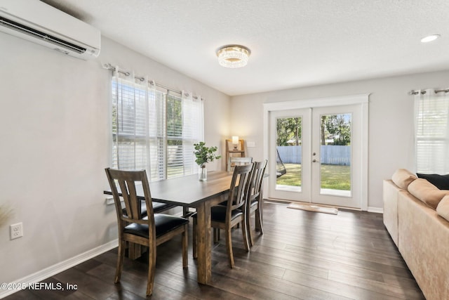 dining space with a wall unit AC, dark hardwood / wood-style flooring, a wealth of natural light, and french doors