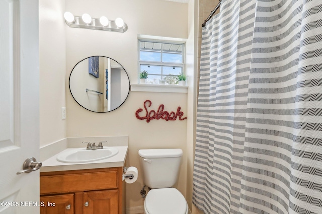 bathroom with vanity, a shower with shower curtain, and toilet