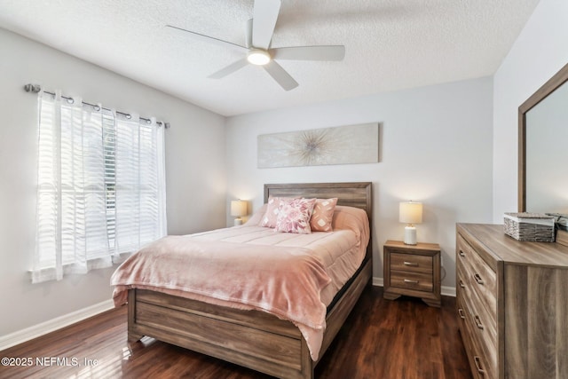 bedroom featuring ceiling fan, dark hardwood / wood-style floors, and a textured ceiling