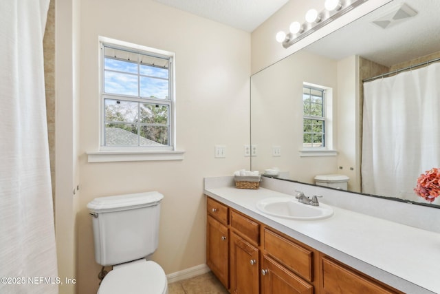 bathroom featuring vanity, toilet, and walk in shower