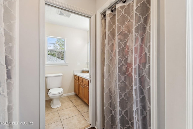 bathroom featuring tile patterned floors, vanity, and toilet