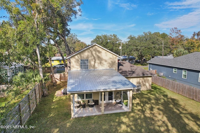 rear view of house with a yard and a patio area