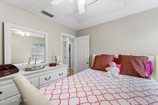 bedroom with a textured ceiling and ceiling fan