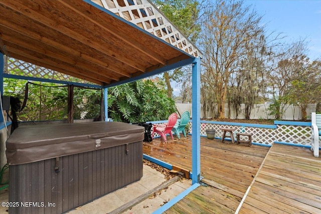 wooden deck with a hot tub