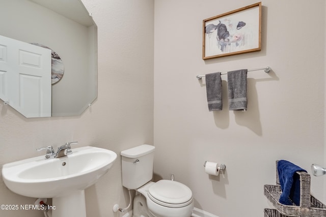 bathroom featuring toilet and sink