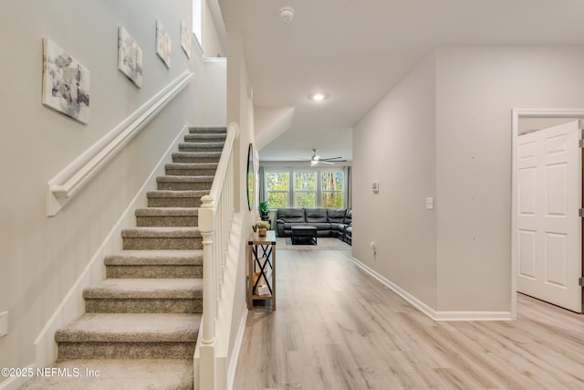 stairway featuring hardwood / wood-style floors and ceiling fan