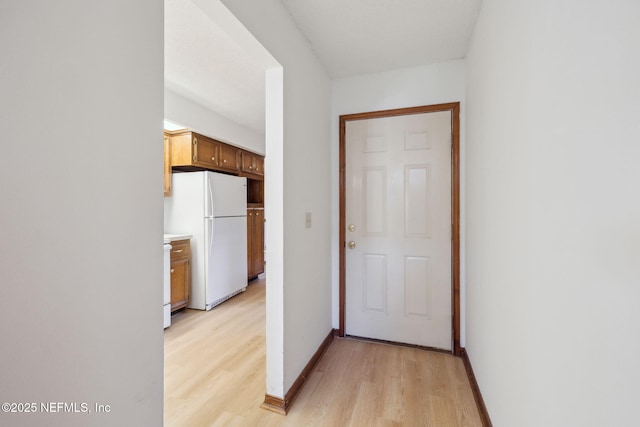 hall with light hardwood / wood-style flooring