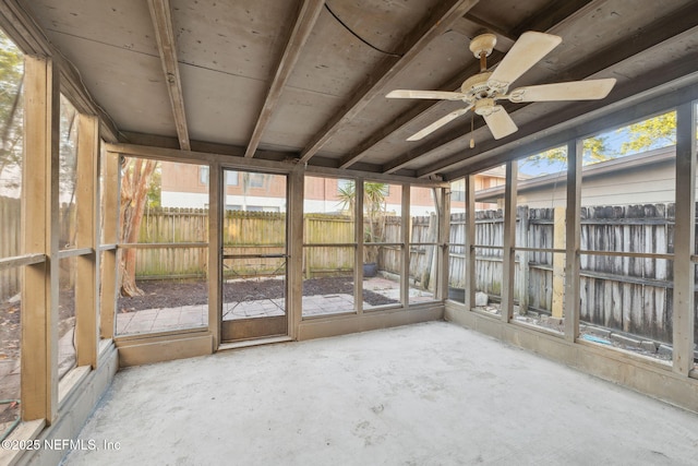 unfurnished sunroom featuring ceiling fan