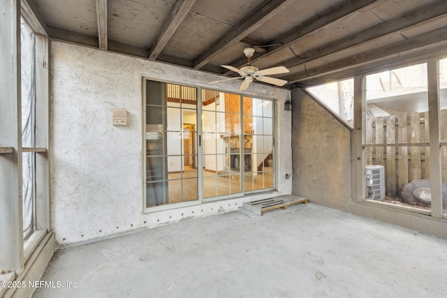 unfurnished sunroom featuring ceiling fan