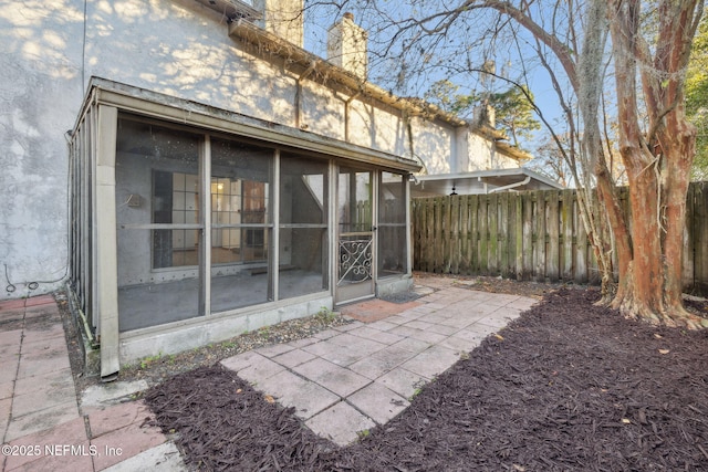 back of house featuring a sunroom