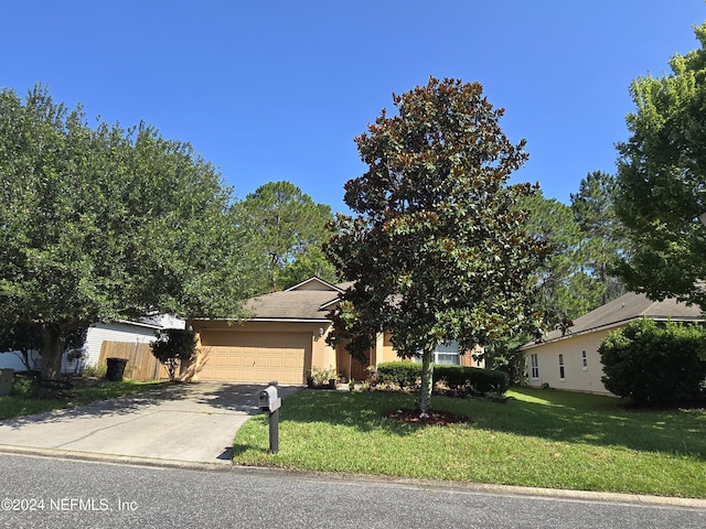 view of front of home with a garage and a front yard