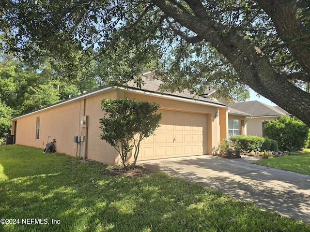 view of home's exterior featuring a yard and a garage