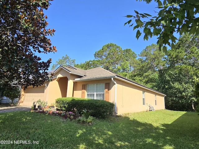 view of home's exterior featuring a garage and a lawn