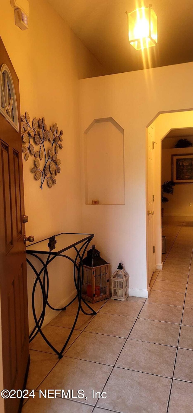 hallway featuring light tile patterned flooring