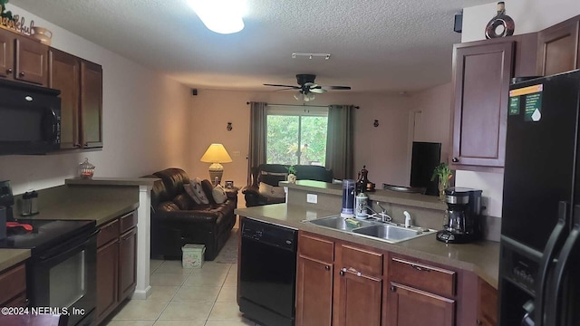 kitchen with black appliances, sink, ceiling fan, light tile patterned floors, and a textured ceiling