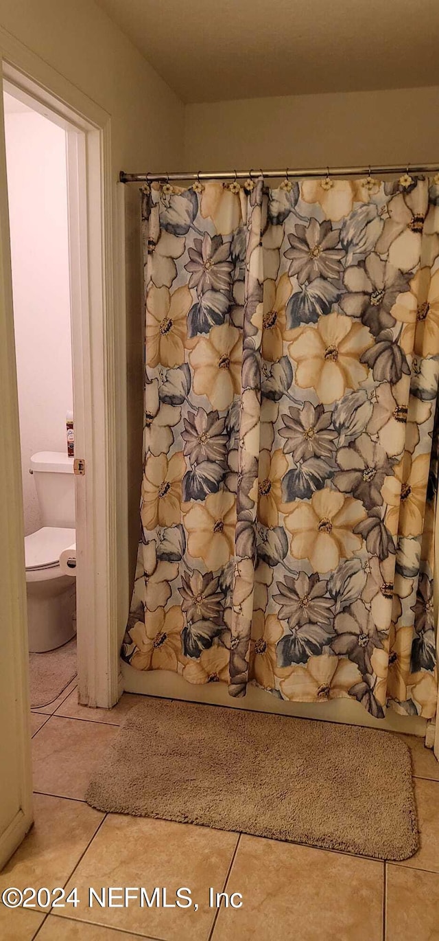 bathroom with tile patterned floors and toilet