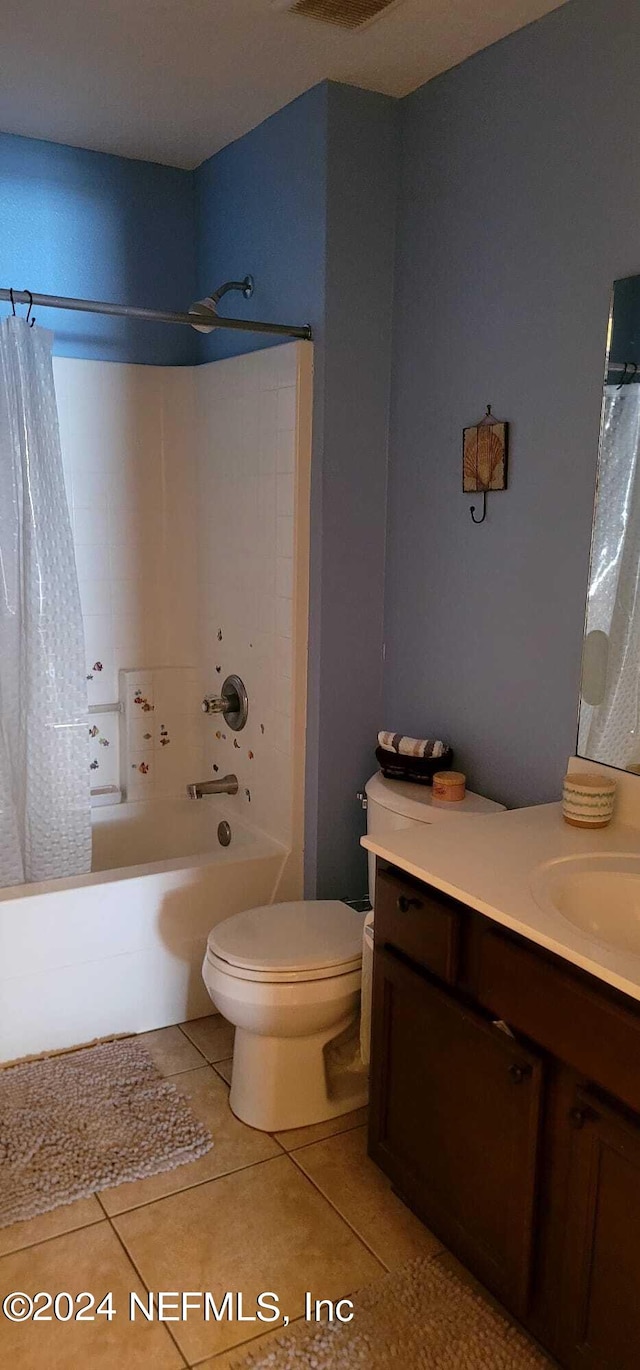 full bathroom with tile patterned floors, vanity, shower / bath combination with curtain, and toilet