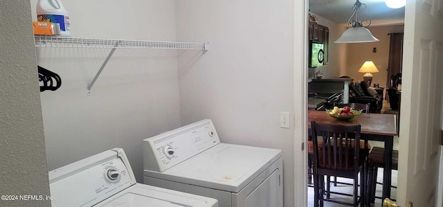 clothes washing area with washer and clothes dryer