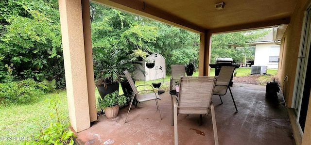 view of patio featuring central AC and a shed